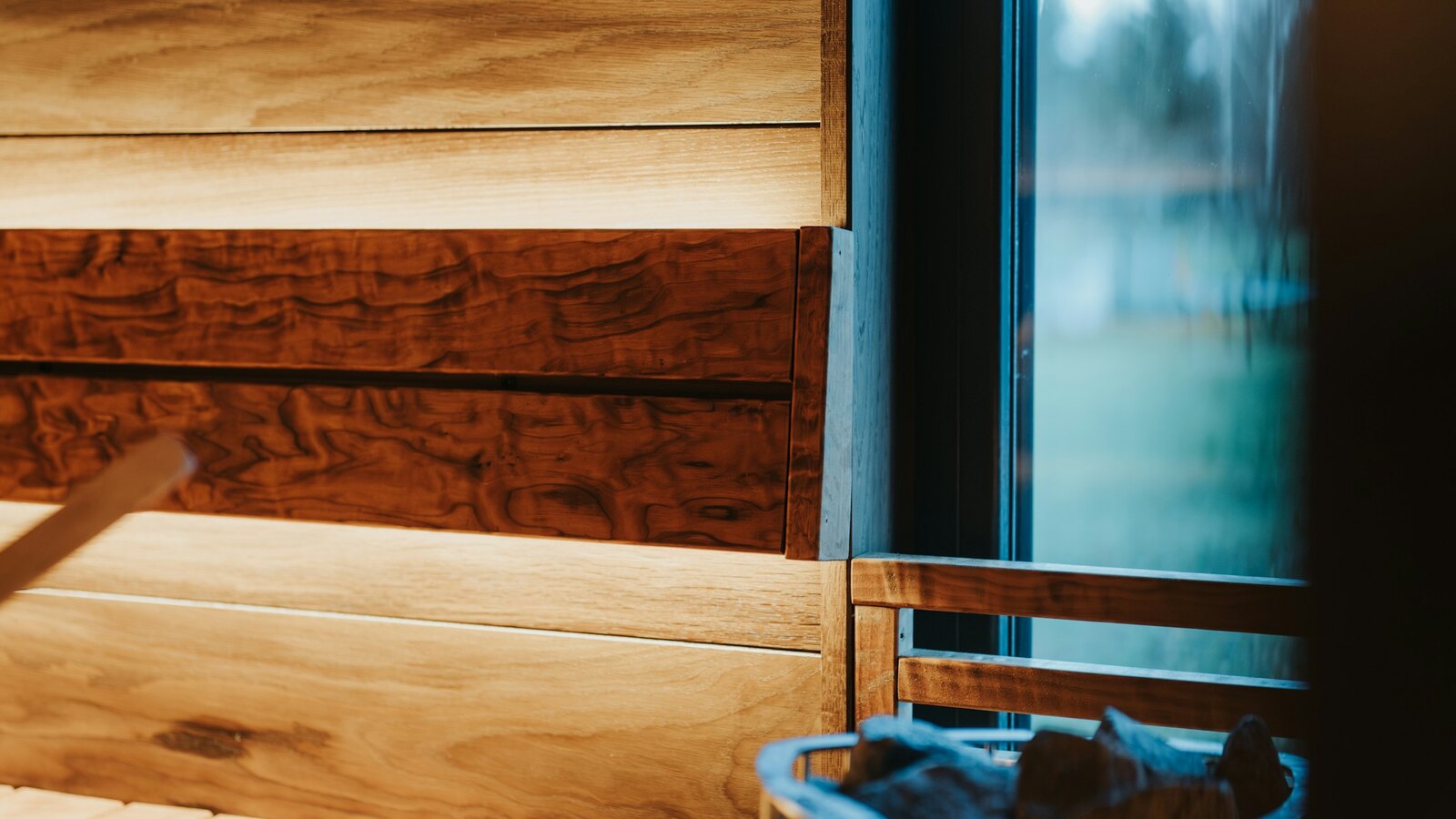A warm wooden Ayurvedic treatment room with linen and brass